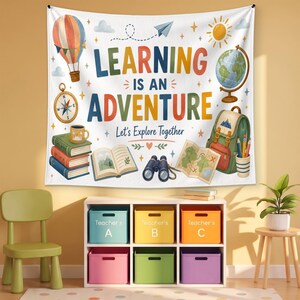 May include: A white wall tapestry featuring the text "LEARNING IS AN ADVENTURE Let's Explore Together" surrounded by illustrations of a hot air balloon, a globe, a compass, a stack of books, an open book, binoculars, a map, and a backpack.