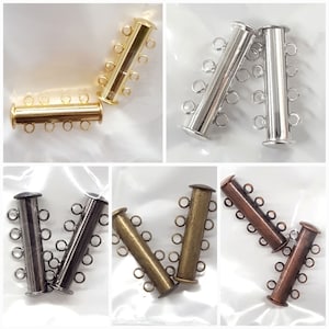 May include: Four sets of magnetic clasps for jewelry making. The clasps are made of metal and come in gold, silver, black, and copper.