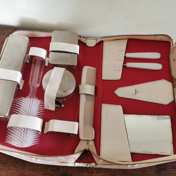 Vintage 1950s travel beauty kit, includes comb, mirror, brush etc. Wear and tear show in photos but a beautiful piece of history