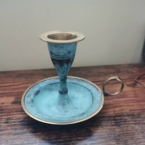 Vintage brass loophole candlestick holder with blue patina
