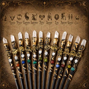 May include: A collection of twelve black wands with gold accents, each topped with a clear quartz crystal point. Each wand features a unique metal zodiac symbol, a small clear rhinestone, and a colored gemstone, corresponding to the zodiac signs.