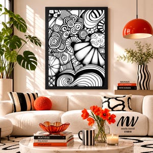 May include: A framed black and white abstract line art print featuring swirling patterns, geometric shapes, and fan-like motifs. The artwork is displayed in a black frame, showcasing a complex composition of monochromatic curves and lines.