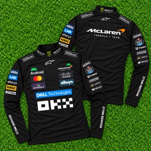May include: A black long-sleeve McLaren Formula 1 Team shirt featuring numerous sponsor logos including Android, Dell Technologies, OKX, Cisco, and Hilton. The design includes white, orange, and multi-colored branding on the front and back.