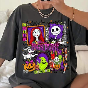 May include: A charcoal gray t-shirt featuring a graphic print of characters from The Nightmare Before Christmas, including Jack Skellington, Sally, Zero, and Oogie Boogie, with the text Welcome to our NIGHTMARE and various Halloween motifs.
