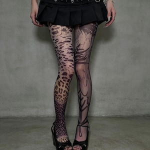 May include: Sheer tights featuring an asymmetrical design with a brown and black leopard print on the left leg and a black botanical leaf pattern on the right leg, paired with a black pleated mini skirt and black open-toe platform heels.