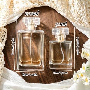 May include: Two clear glass perfume bottles with gold spray nozzles and transparent caps. The larger bottle is 100ml, 12.5cm tall, and 6cm wide. The smaller bottle is 50ml, 9.5cm tall, and 5cm wide.