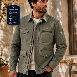 May include: An olive green utility jacket with a collared neckline, front zip, and multiple flap pockets. The chest features the text "loorup". A tag above displays "CUSTOMISE YOUR JACKET" with icons for colour, logo, text, and size options.