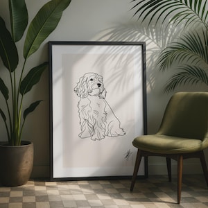 Puede incluir: Una lámina de arte enmarcada que presenta un dibujo de líneas negras de un perro peludo sobre un fondo beige claro. La obra está encerrada en un marco negro fino y muestra una pequeña firma estilizada en la esquina inferior derecha de la imagen.