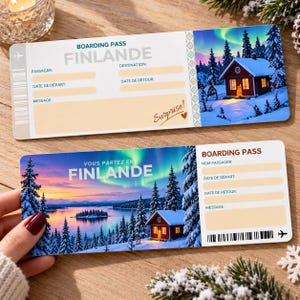 May include: Two rectangular boarding pass templates for a trip to Finland. Each features a winter landscape with a red cabin, snow-covered pine trees, and a vibrant aurora borealis sky. Fields for passenger name, dates, and a message are included.