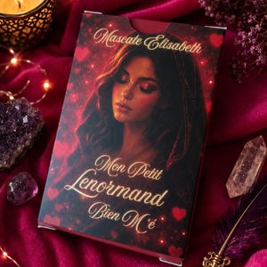 May include: A rectangular deck of cards box featuring a portrait of a person with long dark hair, surrounded by red hearts and glowing lights. The text on the box reads Mascate Elisabeth, Mon Petit Lenormand, and Bien M'é in gold lettering.