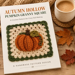May include: A white book titled AUTUMN HOLLOW PUMPKIN GRANNY SQUARE A Crochet Pattern for Cozy Fall Making. The cover features a crocheted square with a cream center, a dark green border, and a three-dimensional orange pumpkin in the middle.
