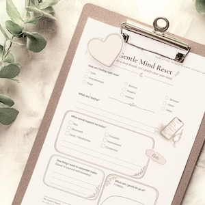 May include: A clipboard holding a Gentle Mind Reset worksheet with sections for feelings, daily support, and reflections. The paper features a heart-shaped clip, checkboxes, and lines for writing, with a soft, neutral design and printed text throughout.