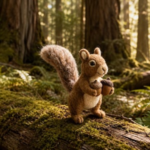May include: A needle-felted squirrel figurine crafted from brown and cream wool, featuring a bushy tail and holding two small brown acorns in its front paws. The squirrel has a textured, fuzzy appearance with dark eyes and a stitched nose.