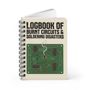 May include: A spiral-bound notebook with a cream-colored cover featuring the black text "LOGBOOK OF BURNT CIRCUITS & SOLDERING DISASTERS" above a graphic of a green circuit board with a smoking, damaged electronic component in the center.