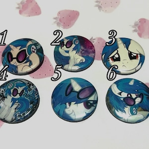 May include: Six circular pin-back buttons featuring illustrations of a blue-maned pony character with headphones and sunglasses. Each button is numbered one through six, displaying various poses and expressions of the character against colourful backgrounds.