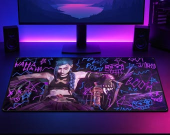 Può includere: Un tappetino da scrivania rettangolare con un'illustrazione grafica di un personaggio con capelli blu intrecciati, che indossa un top nero, circondato da testi e simboli in stile graffiti al neon tra cui HAHA, POW, BOOM e JINXED in rosa e blu.