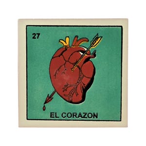 May include: A square tile featuring a green background with the number 27 in the top left corner. A red anatomical heart pierced by a yellow arrow is centered, with the text EL CORAZON printed in black capital letters along the bottom edge.