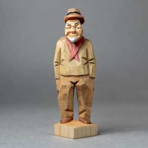 Handgesneden beeldje van lindenhout, rustieke platte sculptuur in volkskunststijl.