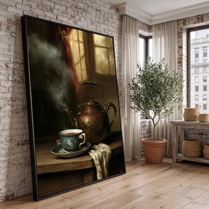 May include: A large framed wall art print depicting a still life scene with a steaming copper kettle and a floral patterned teacup on a wooden table. The artwork is displayed in a room with a brick wall, a potted olive tree, and a window.