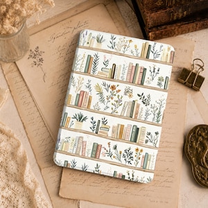 May include: A rectangular tablet case featuring a repeating pattern of horizontal wooden shelves filled with various colorful books and potted plants. The design includes illustrations of green foliage, small yellow and orange flowers, and books in shades of red, green, blue, and cream against a white background.