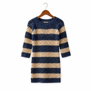 May include: A long-sleeve sweater dress featuring a crochet granny square pattern with alternating horizontal stripes in dark navy blue and cream. The garment has a round neckline, ribbed trim at the collar, and is displayed on a wooden hanger.