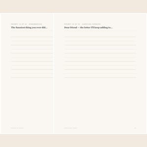 Op de afbeelding: Een open dagboek met twee pagina's met gelinieerde schrijfgedeelten. De linkerpagina toont de tekst 'PROMPT 10 OF 30 - REMEMBERING' en 'The funniest thing you ever did....' De rechterpagina toont 'PROMPT 11 OF 30 - CARRYING FORWARD' en 'Dear friend &ndash; the letter I'll keep adding to...'