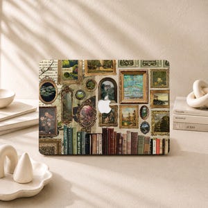Puede incluir: Una funda para portátil con un collage de varios cuadros de paisajes y naturalezas muertas, lomos de libros antiguos y texturas de papel envejecido. El diseño incluye un recorte para el logotipo de Apple en el centro y una fila de libros.