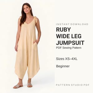 May include: A light peach-colored wide-leg jumpsuit with tie-shoulder straps and side pockets. The text reads: INSTANT DOWNLOAD RUBY WIDE LEG JUMPSUIT PDF Sewing Pattern Sizes XS-4XL Beginner PATTERN STUDIO PDF.