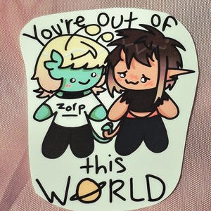 May include: A die-cut sticker featuring two cartoon characters with the text "You're out of this WORLD". One character is light green with blonde hair wearing a white "zorp" shirt, and the other is tan with dark hair. A small planet icon replaces the "O".