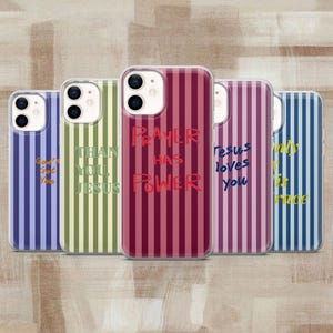 May include: Five smartphone cases with vertical stripes in various colors. The cases feature text including God's Got You, Than You Jesus, Prayer Has Power, Jesus Loves You, and Only It Is Grace, each printed in a color contrasting with the stripes.