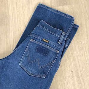 May include: A pair of blue denim jeans with a back pocket featuring a stitched