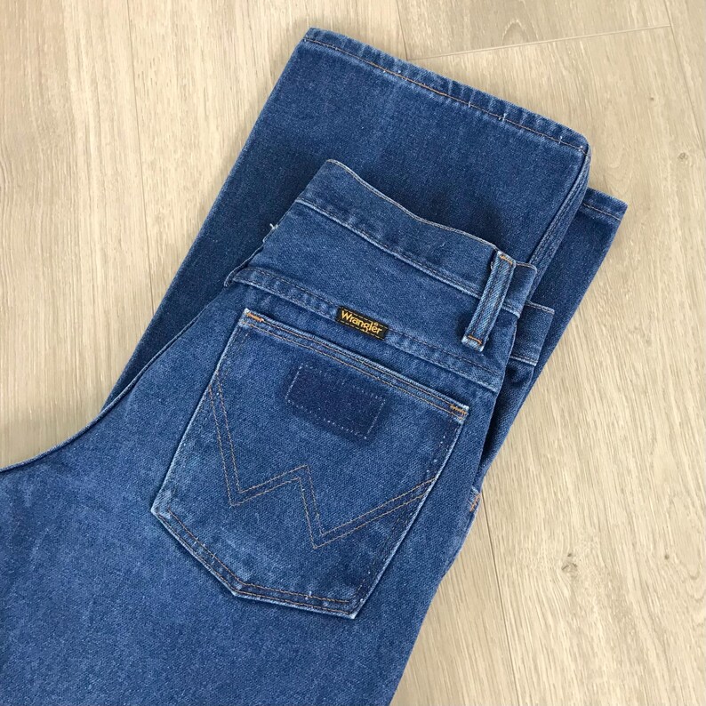 May include: A pair of blue denim jeans with a back pocket featuring a stitched