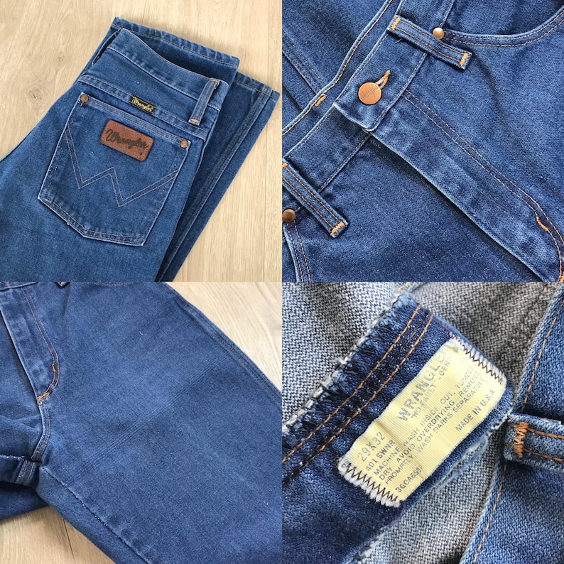 May include: Blue denim Wrangler jeans with a classic five-pocket design. Features a brown leather patch with the Wrangler logo on the back pocket. The jeans have a button and zipper closure and are size 29x32.