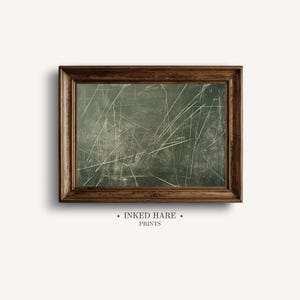 May include: A rectangular wall art piece featuring a dark olive green background with numerous thin, white, intersecting diagonal lines resembling scratches. The artwork is encased in a dark brown wooden frame with a visible grain texture.