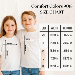 May include: Comfort Colors 9018 size chart featuring a table with width and length measurements in inches for sizes XS through XL. The table lists XS as 13.50 by 18.75 inches, S as 14.50 by 20.50 inches, M as 16.50 by 21.50 inches, L as 17.50 by 22.75 inches, and XL as 19.50 by 26.00 inches.