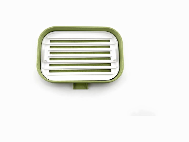 Close top view of the white ripple tray with its drying ribs and drain slots