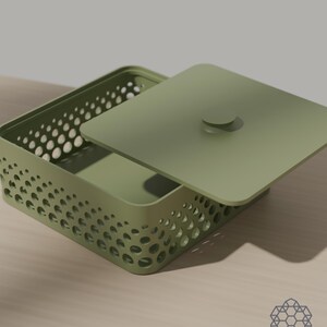 May include: A sage green rectangular storage box with a matching lid featuring a central circular handle. The sides of the box are constructed with a perforated pattern of varying circular cutouts that create a gradient effect across the surface.