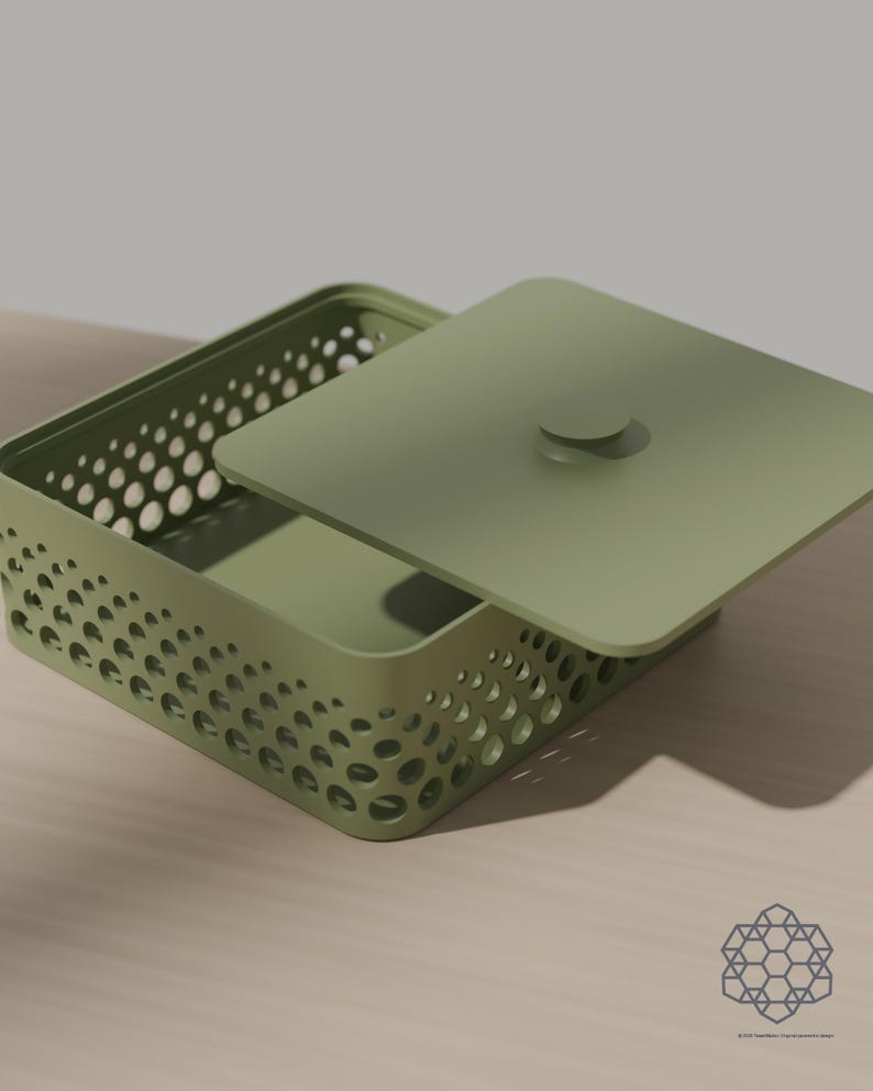 May include: A sage green rectangular storage box with a matching lid featuring a central circular handle. The sides of the box are constructed with a perforated pattern of varying circular cutouts that create a gradient effect across the surface.