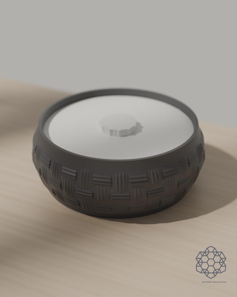Dark grey woven storage bowl with white drop-in lid on a sunlit table. 3D-rendered visualization of the exact print file.