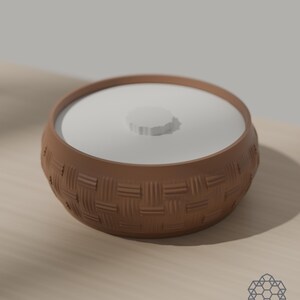 Earth brown woven storage bowl with white drop-in lid on a sunlit table. 3D-rendered visualization of the exact print file.
