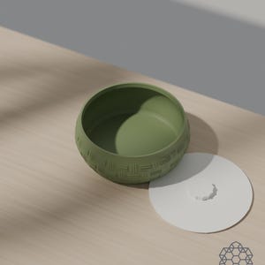 Lid off: the matcha green woven bowl shows its smooth rounded interior, with the white lid lying beside it. 3D-rendered visualization of the exact print file.