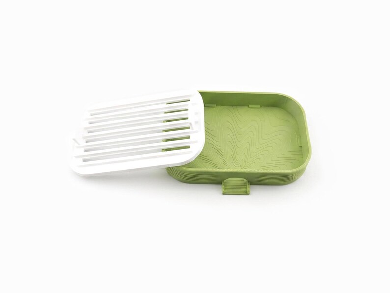 White ripple tray lifted out and leaning against the edge of the matcha green soap dish
