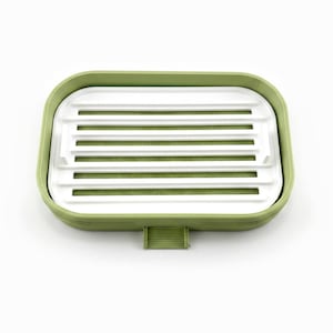Top view of the matcha green soap dish with its white ripple drying tray inside, on a white background