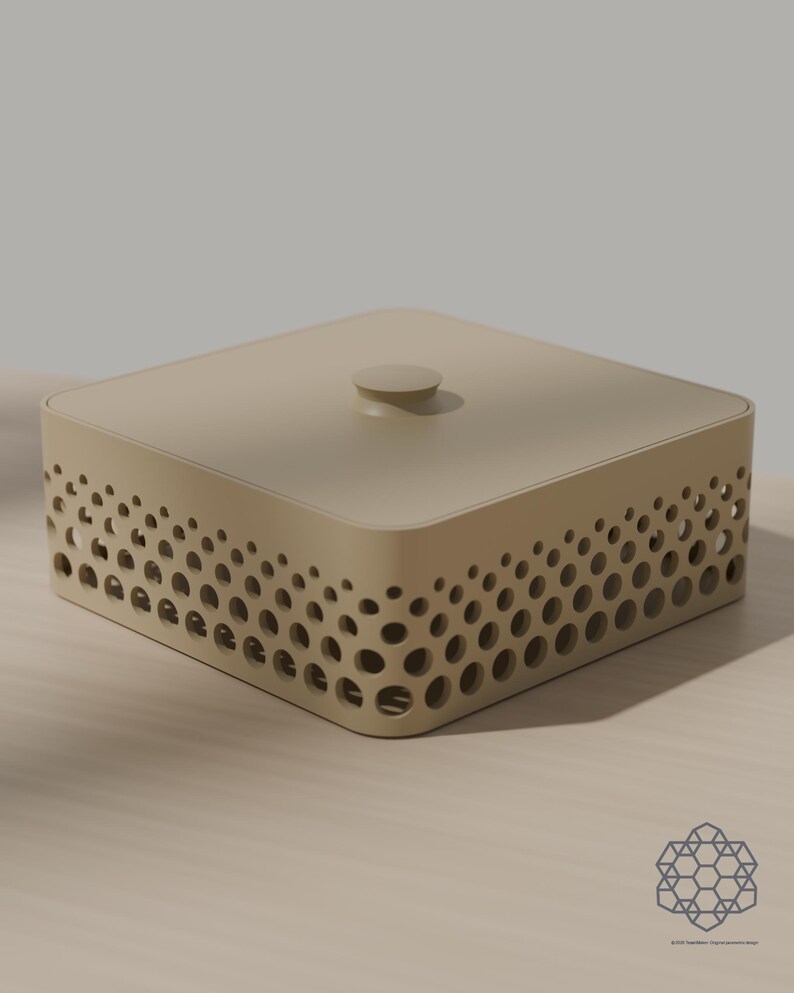 May include: A square, beige storage box with a flat lid and a small central knob. The sides feature a decorative pattern of circular cutouts that vary in size, creating a gradient effect. The box has rounded corners and a smooth, matte finish.