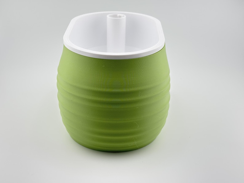 Aquaoval oblong self-watering planter in matcha green, assembled with the white soil insert seated in the top and the fill tube standing up at the centre.