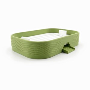 Angled view of the soap dish showing the wavy ribbed texture on its matcha green sides