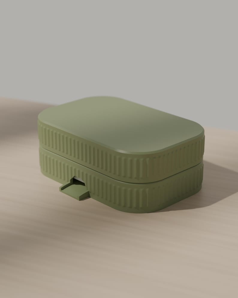 May include: A rectangular olive green storage box with rounded corners and a ribbed texture along the sides. The container features a flat lid and a small, protruding tab on the front edge for opening, showcasing a clean and functional design.
