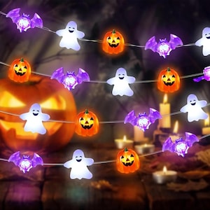 May include: A string of Halloween decorative lights featuring alternating shapes of white ghosts, orange jack-o'-lantern pumpkins, and purple bats. The figures are illuminated and connected by a thin, clear wire, creating a festive lighting display.