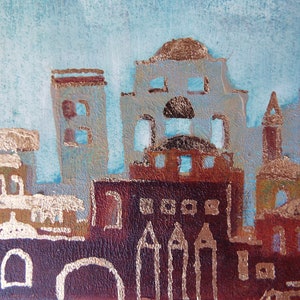 May include: A watercolor painting of a cityscape with buildings in shades of blue, brown, and gold. The buildings have gold accents and some have windows. The sky is a light blue color.