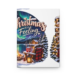 May include: A notebook cover featuring a winter scene with a snowy landscape, a lake, a cabin, and a wooden chair with a red plaid blanket. The text reads Christmas is a Feeling and Warm Thoughts on a mug. An aurora borealis glows in the night sky.